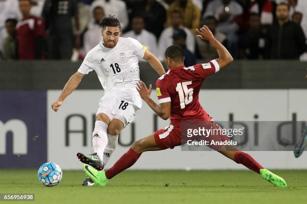 Pedro Correia of Qatar in action against Alireza Jahan Bakhsh of Iran during the 2018 FIFA World Cup Asian Qualifying group A football match between...