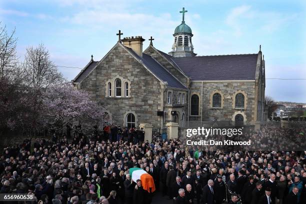 The funeral cortege leaves St Columba's Church and makes it way to Derry City Cemetery on March 23, 2017 in Londonderry, Northern Ireland. The...