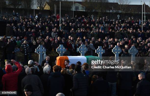 Thousands of mourners gather at Derry cemetery as Emmett McGuinness and Fiachra McGuinness carry the coffin of their late father Martin McGuinness on...