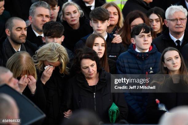 Martin McGuinness's wife Bernadette and other family members stand at the graveside at Martin McGuinness' Funeral at the Derry City Cemetery on March...