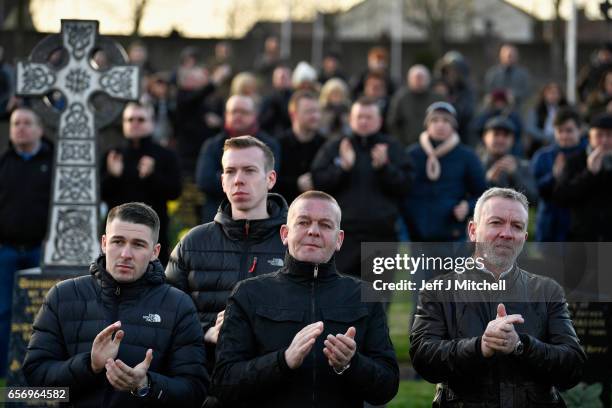 Mourners look on during Martin McGuinness' Funeral at the Derry City Cemetery on March 23, 2017 in Londonderry, Northern Ireland. The funeral is held...