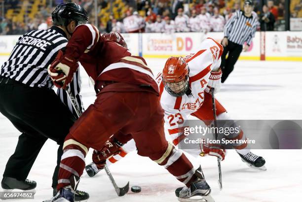 Boston University Terriers forward Jakob Forsbacka Karlsson faces off with Boston College Eagles forward Graham McPhee during a Hockey East semifinal...