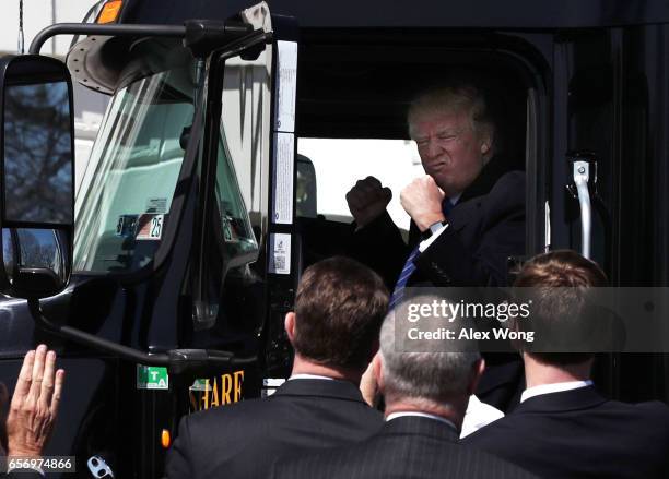 President Donald Trump sits in the cab of a truck as he welcomes members of American Trucking Associations to the White House March 23, 2017 in...