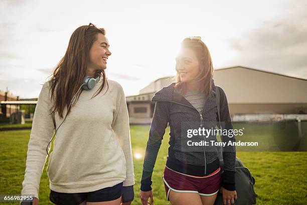 Young women athletes leaving playing field