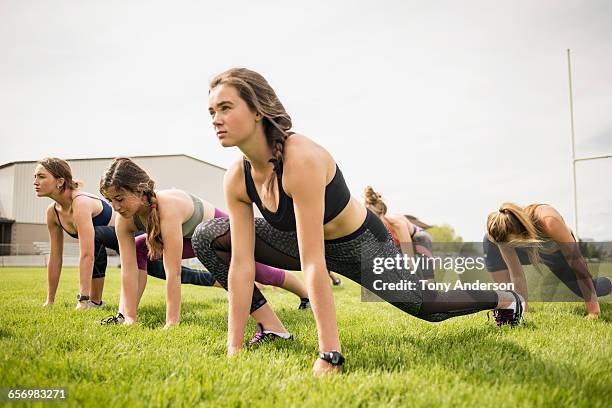 young women athletes on school playing field - teens exercising stock pictures, royalty-free photos & images