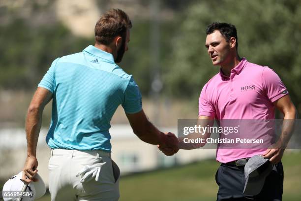 Dustin Johnson shakes hands with Martin Kaymer of Germany after winning his match during round two of the World Golf Championships-Dell Technologies...