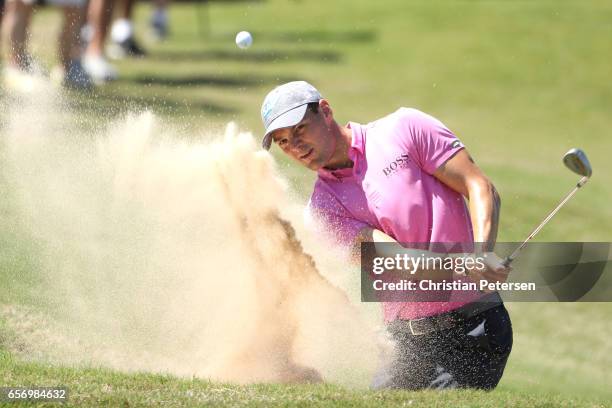 Martin Kaymer of Germany plays a shot from a bunker on the 14th hole of his match during round two of the World Golf Championships-Dell Technologies...