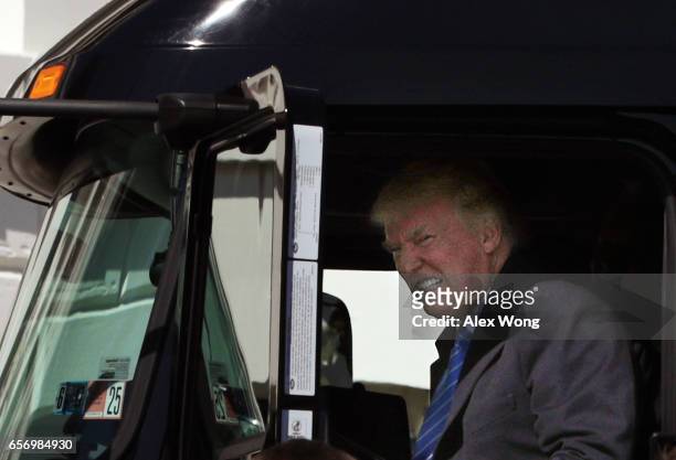 President Donald Trump sits in the cab of a truck as he welcomes members of American Trucking Associations to the White House March 23, 2017 in...