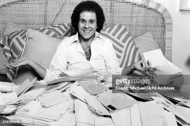 Fitness guru Richard Simmons poses for a portrait session with a pike of fan mail for playing himself on the TV show "General Hospital" in August...