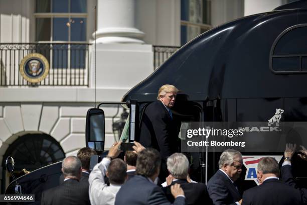 President Donald Trump stands on a tractor trailer during an event with truckers and truck industry chief executive officers on the South Lawn of the...