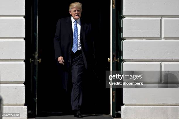 President Donald Trump walks out of the White House to meet truckers and truck industry chief executive officers on the South Lawn of the White House...