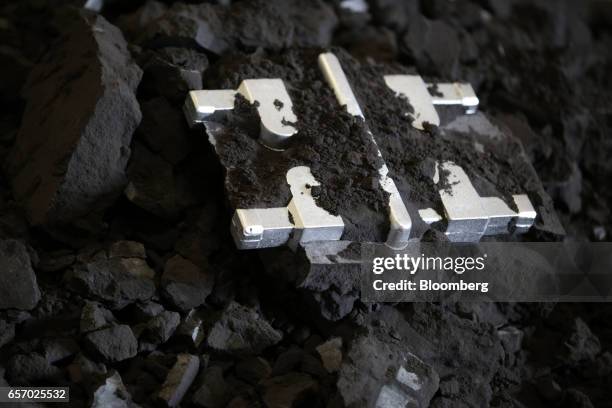 Aluminum components sit partially covered in a pile of green sand molds at the foundry inside the Super Vac Manufacturing Co. Production facility in...