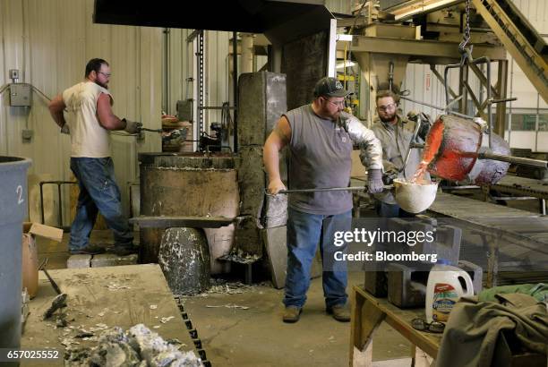 Employees pour melted aluminum while working in the foundry at the Super Vac Manufacturing Co. Production facility in Fort Collins, Colorado, U.S.,...
