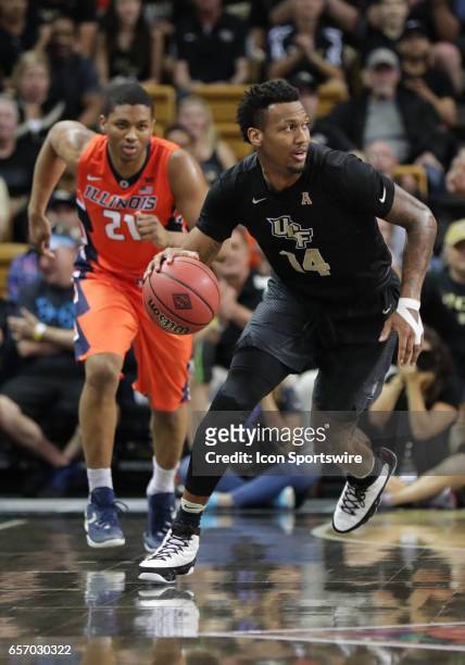 Knights forward Nick Banyard bring the ball up court and is followed by Illinois Fighting Illini guard Malcolm Hill during the 2017 NIT Championship...