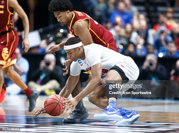 Mustangs guard Jarrey Foster and USC Trojans guard Elijah Stewart of after a loose ball during the NCAA Tournament first round game game between the...