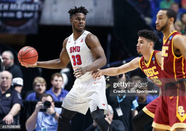 Mustangs forward Semi Ojeleye looks for a teammate to pass to as USC Trojans forward Bennie Boatwright defends during the NCAA Tournament first round...