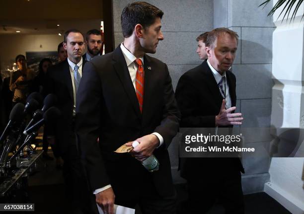 Speaker of the House Paul Ryan walks with OMB Director Mick Mulvaney to a meeting of the House Republican caucus at the U.S. Capitol March 23, 2017...