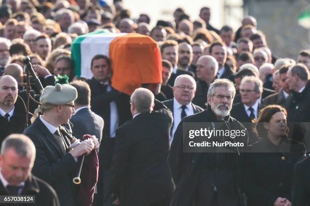 Sinn Fein Mary Lou McDonald and Sinn Fein President Gerry Adams, walk in front of the coffin of former Northern Ireland Deputy First Minister Martin...