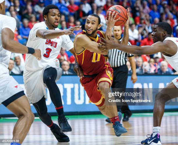 Trojans guard Jordan McLaughlin drives to the basket as SMU Mustangs guard Sterling Brown defends during the NCAA Tournament first round game game...