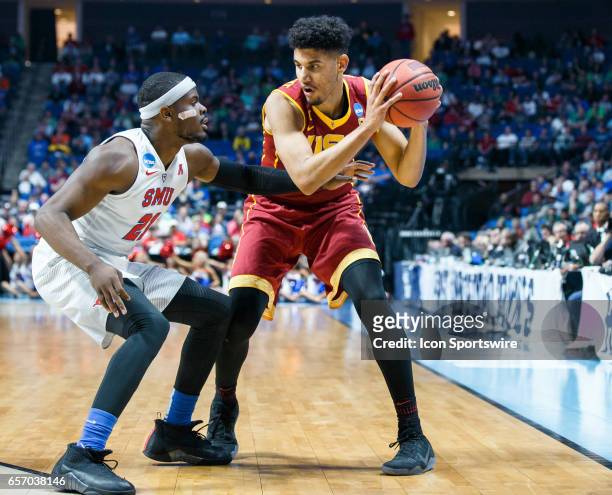 Trojans forward Bennie Boatwright looks to make a move as SMU Mustangs guard Ben Emelogu II defends during the NCAA Tournament first round game game...