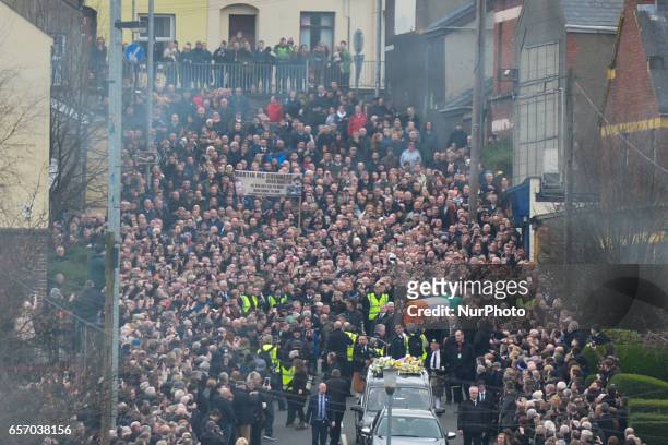 The coffin of former Northern Ireland Deputy First Minister Martin McGuinness is taken away from his house just ahead of the procession in the...