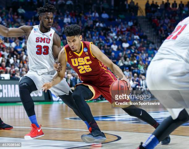 Trojans forward Bennie Boatwright drives to the basket as SMU Mustangs forward Semi Ojeleye defends during the NCAA Tournament first round game game...