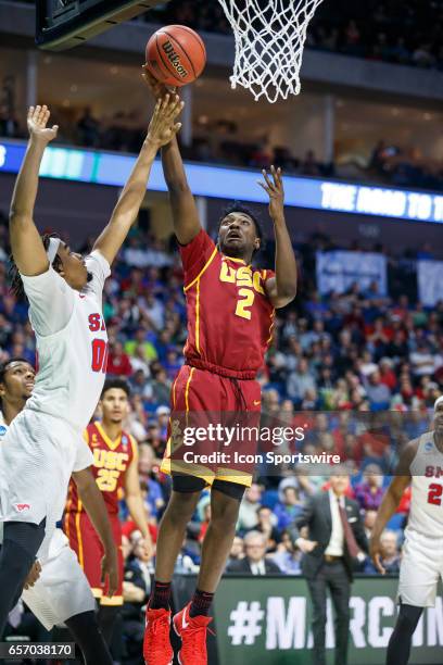Trojans guard Jonah Mathews shoots over SMU Mustangs forward Ben Moore during the NCAA Tournament first round game game between the SMU Mustangs and...