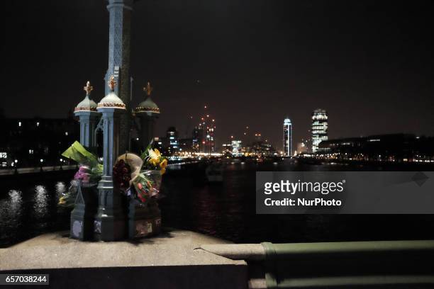 Flowers on Westminster bridge in central London on March 23, 2017 in solidarity with the victims of the March 22 terror attack at the British...