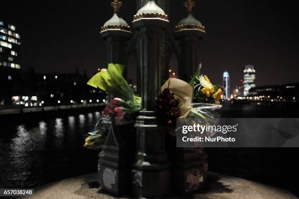 Flowers on Westminster bridge in central London on March 23, 2017 in solidarity with the victims of the March 22 terror attack at the British...