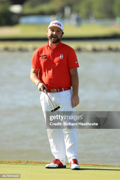 Andy Sullivan of England reacts after his putt is blown by the wind on the 13th hole of his match during round two of the World Golf...