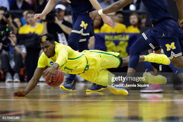 Dylan Ennis of the Oregon Ducks battles for a loose ball in the first half against the Michigan Wolverines during the 2017 NCAA Men's Basketball...