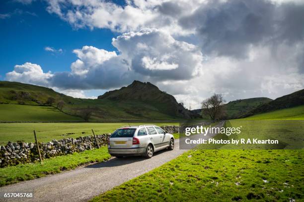 car driving on a narrow country road in beautiful scenery - domestic car stock-fotos und bilder