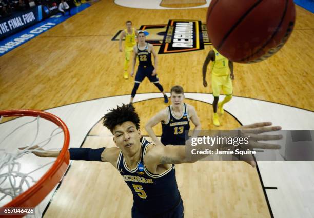 Wilson of the Michigan Wolverines blocks a shot in the first half against the Oregon Ducks during the 2017 NCAA Men's Basketball Tournament Midwest...