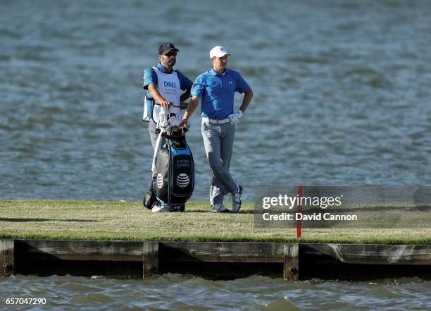 Jordan Spieth of the United States waits to play his third shot with his caddie Michael Greller on the par 4, 13th hole in his match against Yuta...