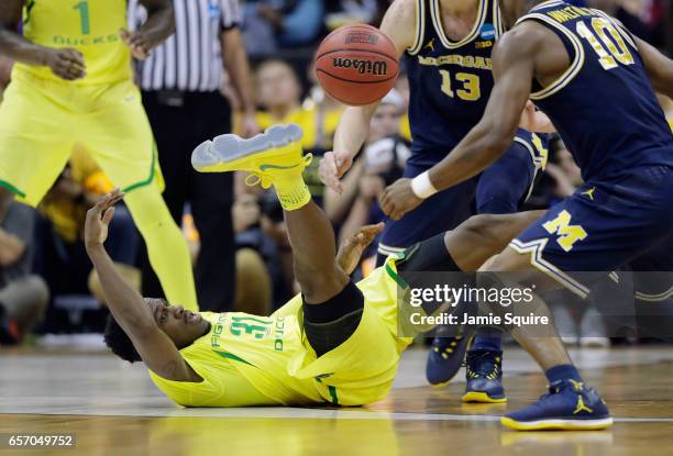 Dylan Ennis of the Oregon Ducks battles for a loose ball in the first half against the Michigan Wolverines during the 2017 NCAA Men's Basketball...