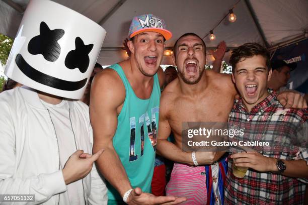 Marshmello, New England Patriots tight end Rob Gronkowski, Mojo Rawley, and Martin Garrix attend the SiriusXM Music Lounge at 1 Hotel South Beach on...