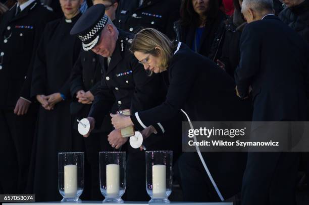 Acting Met Commissioner Craig Mackey and Home Secretary Amber Rudd light candles in memory of the victims of Westminster terrorist attack during a...