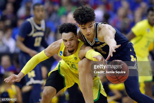 Dillon Brooks of the Oregon Ducks and D.J. Wilson of the Michigan Wolverines battle for the ball in the second half during the 2017 NCAA Men's...