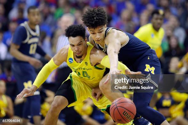 Dillon Brooks of the Oregon Ducks and D.J. Wilson of the Michigan Wolverines battle for the ball in the second half during the 2017 NCAA Men's...