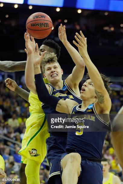 Wilson and Moritz Wagner of the Michigan Wolverines battle for a rebound in the second half against the Oregon Ducks during the 2017 NCAA Men's...