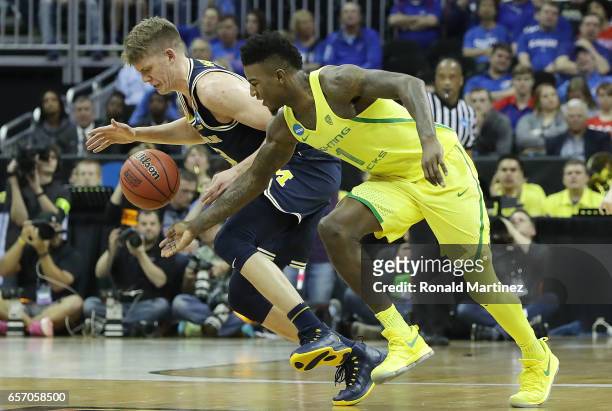 Moritz Wagner of the Michigan Wolverines is defended by Jordan Bell of the Oregon Ducks during the 2017 NCAA Men's Basketball Tournament Midwest...
