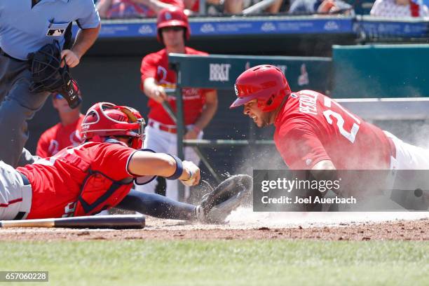 Jose Lobaton of the Washington Nationals tags out Jhonny Peralta of the St Louis Cardinals out for the final out in the first inning during a spring...