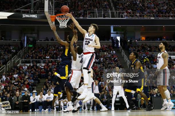 Zach Collins of the Gonzaga Bulldogs blocks a shot by Tarik Phillip of the West Virginia Mountaineers in the first half during the 2017 NCAA Men's...