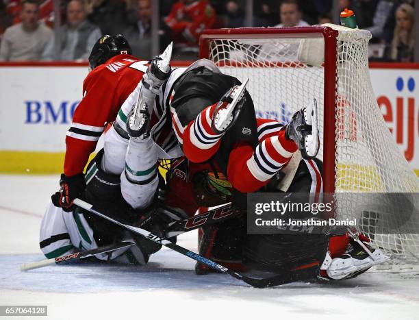 Devin Shore of the Dallas Stars colides with Corey Crawford and Trevor van Riemsdyk of the Chicago Blackhawks at the United Center on March 23, 2017...
