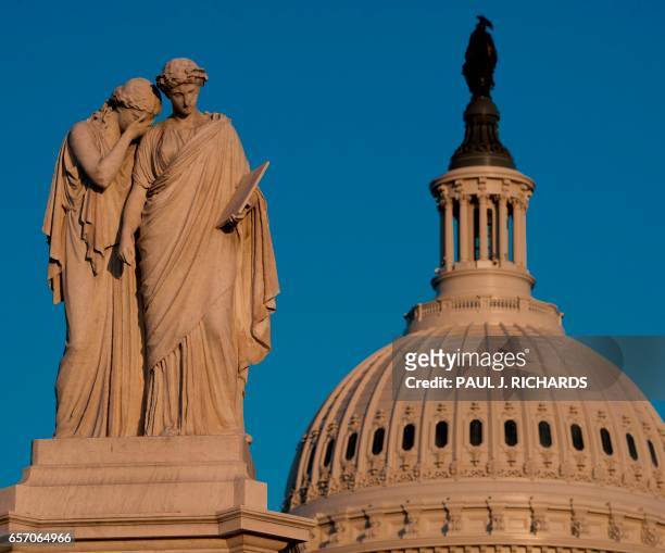 The Peace Monument is seen at sunset March 23 on the grounds of the US Capitol in Washington, DC. - A white marble 44-ft high statue was erected in...