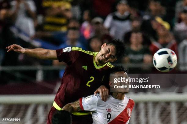 Venezuela's defender Wilker Angel vies for the ball with Peru's forward Paolo Guerrero during their 2018 FIFA World Cup qualifier football match in...