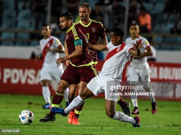 Peru's forward Andre Carrillo vies for the ball with Venezuela's midfielder Tomas Rincon during their 2018 FIFA World Cup qualifier football match in...