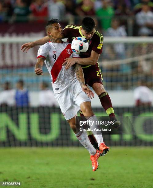 Paolo Guerrero of Peru and Walker Angel of Venezuela jump for the ball during a match between Venezuela and Peru as part of FIFA 2018 World Cup...
