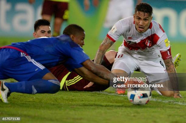 Peru's forward Paolo Guerrero vies for the ball with Venezuela's goalkeeper Wuilker Farinez during their 2018 FIFA World Cup qualifier football match...