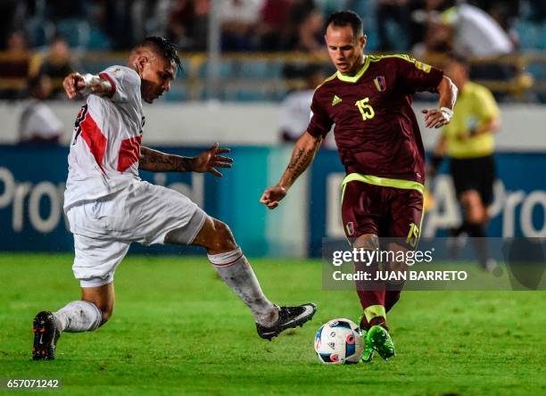 Venezuela's midfielder Alejandro Guerra vies for the ball with Peru's forward Paolo Guerrero during their 2018 FIFA World Cup qualifier football...